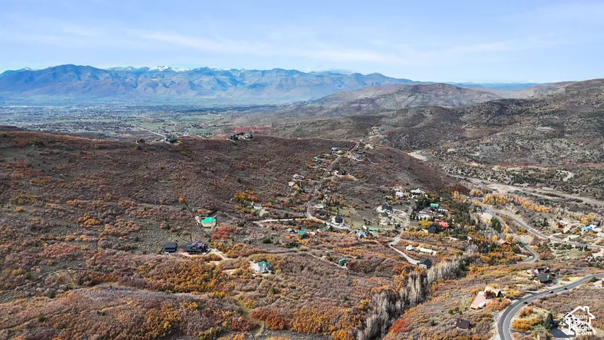 Elevated aerial perspective featuring expansive mountain range surroundings and hilly topography with natural shrubland vegetation