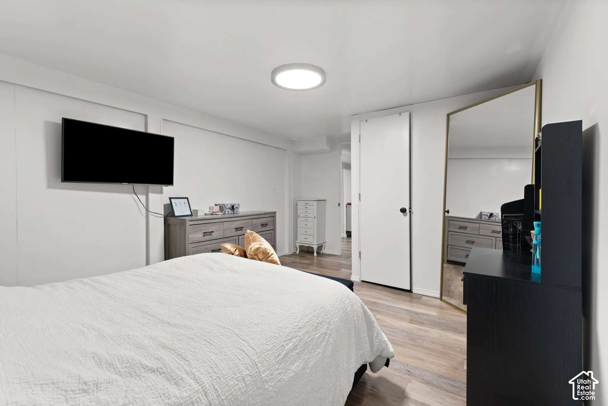 Room featuring wood-finish flooring, recessed lighting, and a neutral color palette