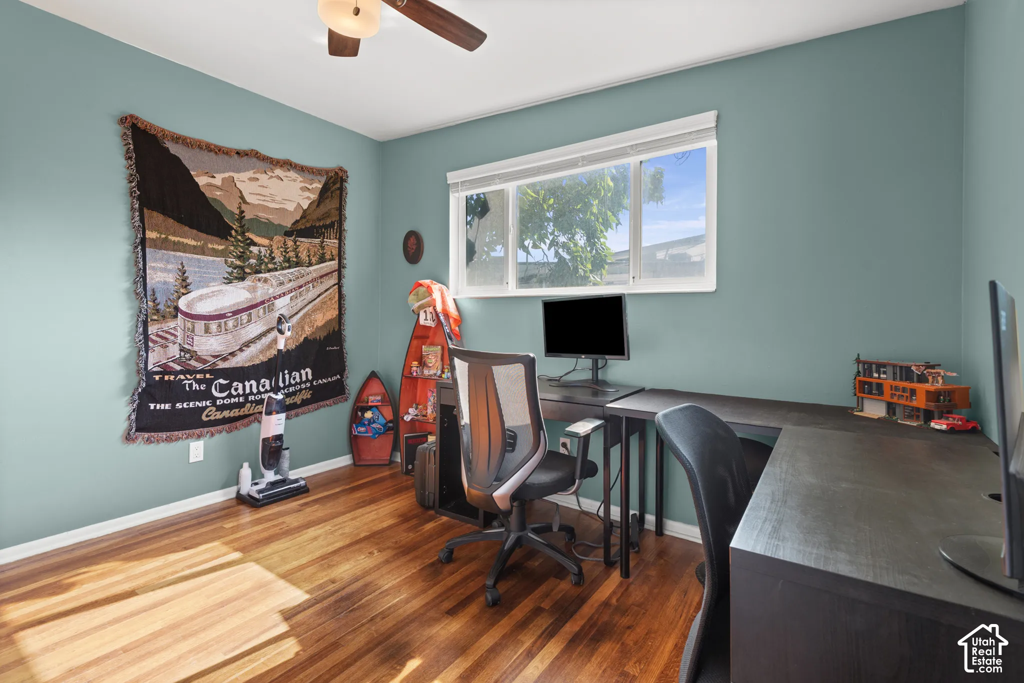 Wood-finish flooring, horizontal sliding window, and ceiling-mounted fan with light fixture