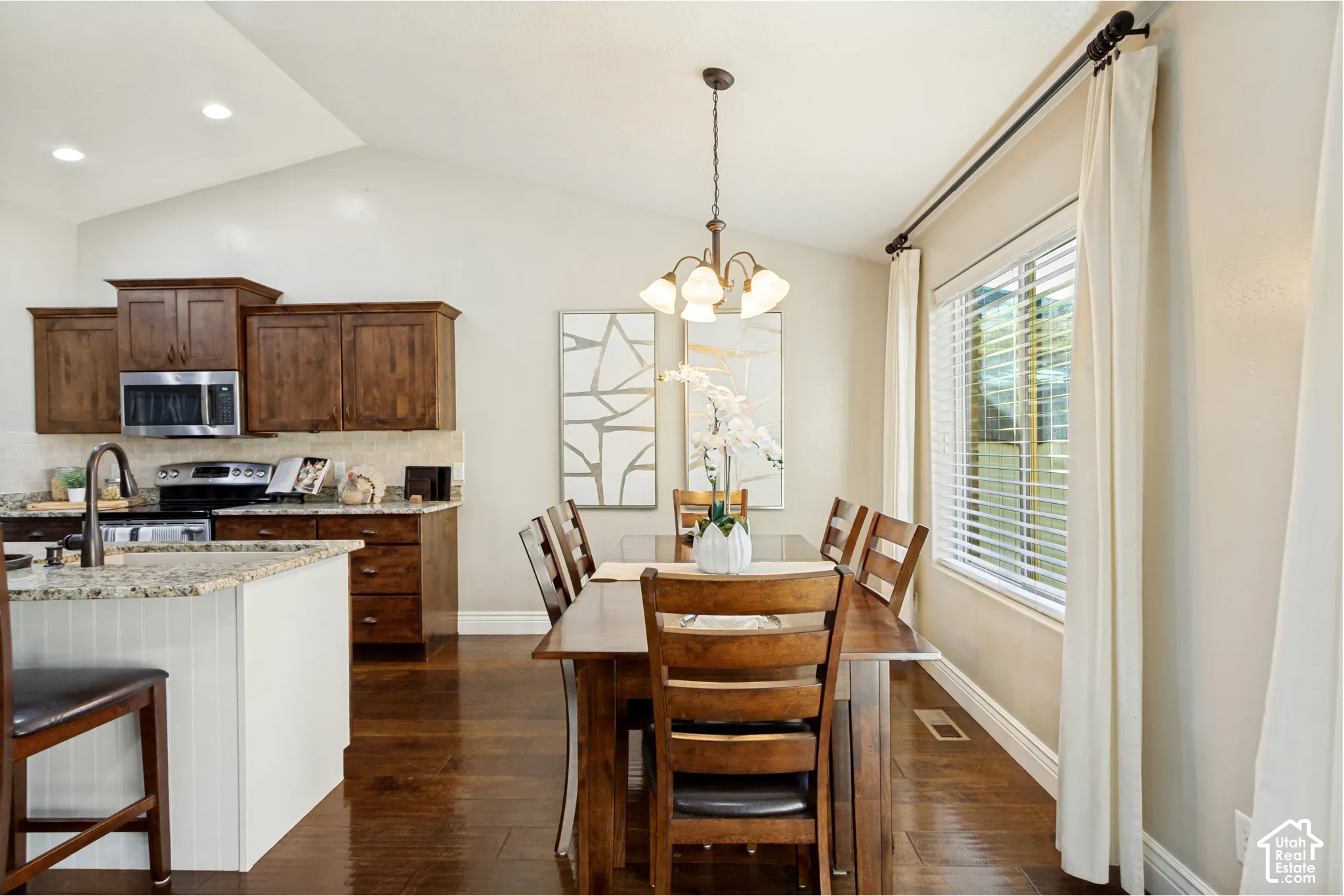 Vaulted ceilings, hardwood flooring, granite countertops, recessed lighting, and a multi-arm pendant chandelier