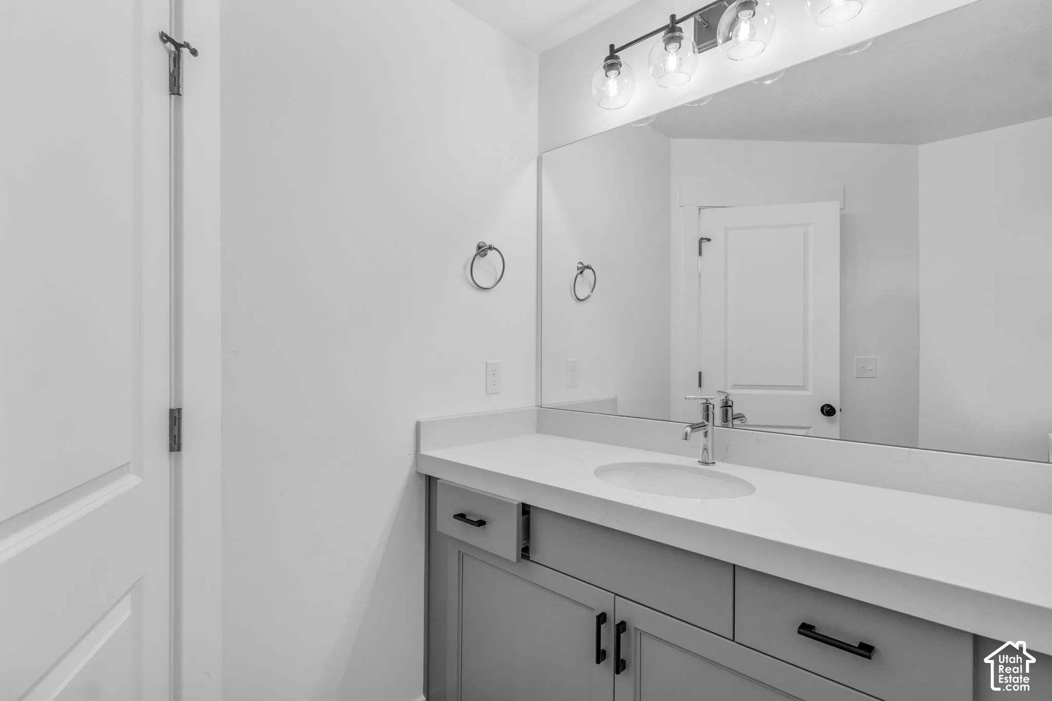 Full secondary bath with extended vanity, painted wood cabinets and quartz slab countertops.