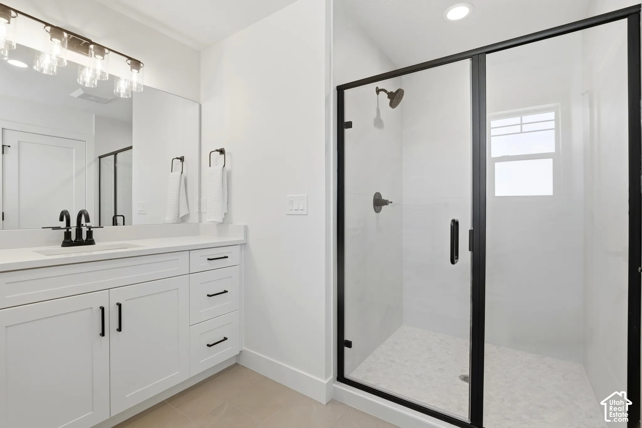 White vanity with solid surface countertop and undermount sink