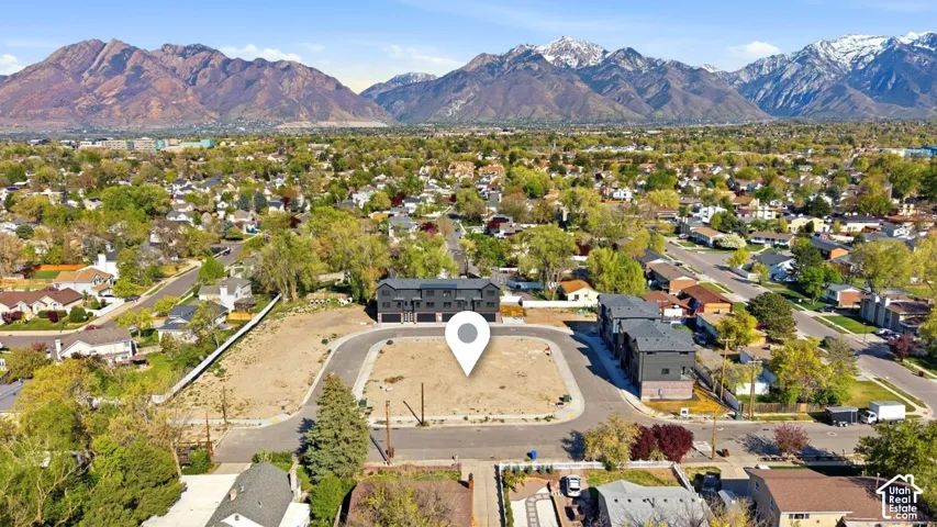 Undeveloped residential parcel featuring paved street access and a backdrop of mountain peaks