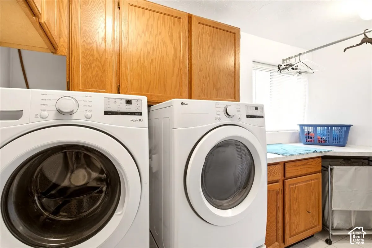 Laundry area featuring natural wood-finish cabinetry, white countertop surface, and wall-mounted garment hanging rod