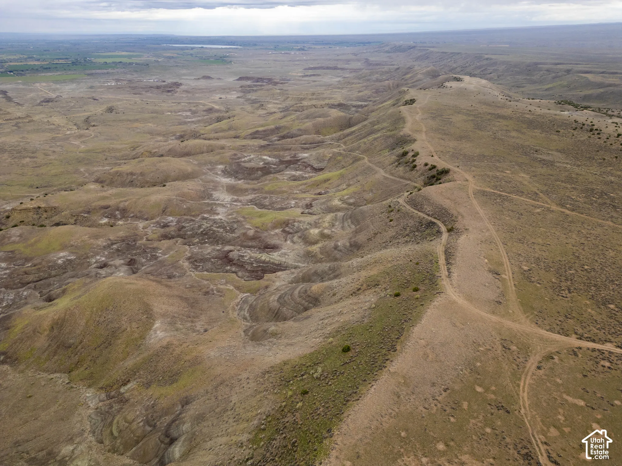 Expansive landscape featuring rolling topography, ridgelines, and diverse earth-tone terrain