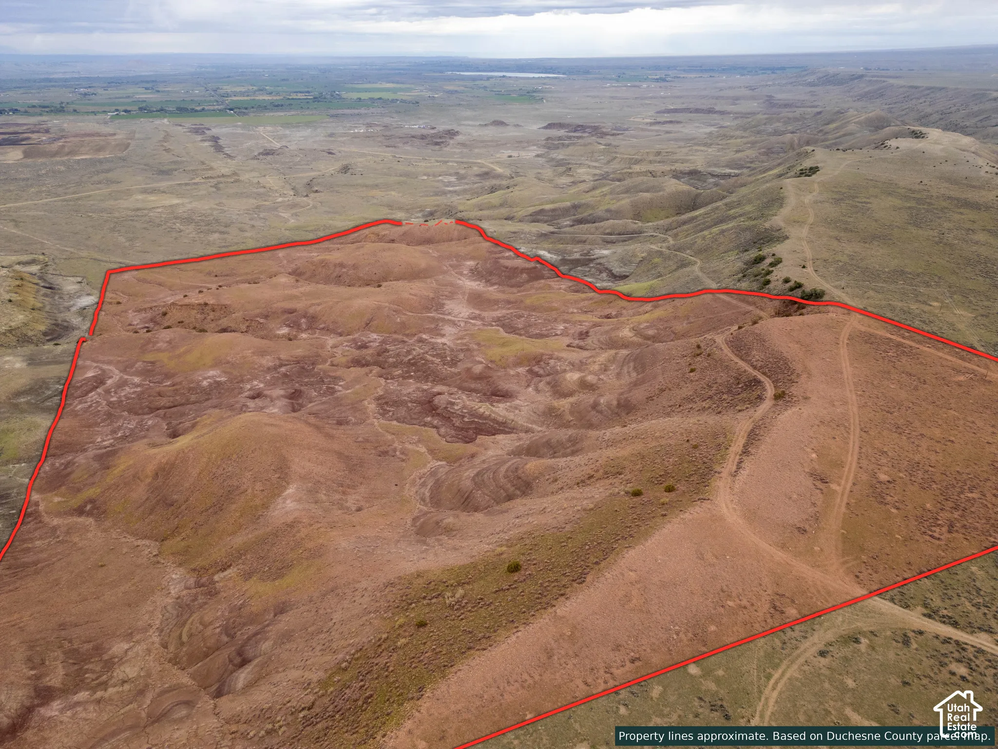 Expansive parcel featuring undulating desert terrain, natural ridge formations, and dirt access trails