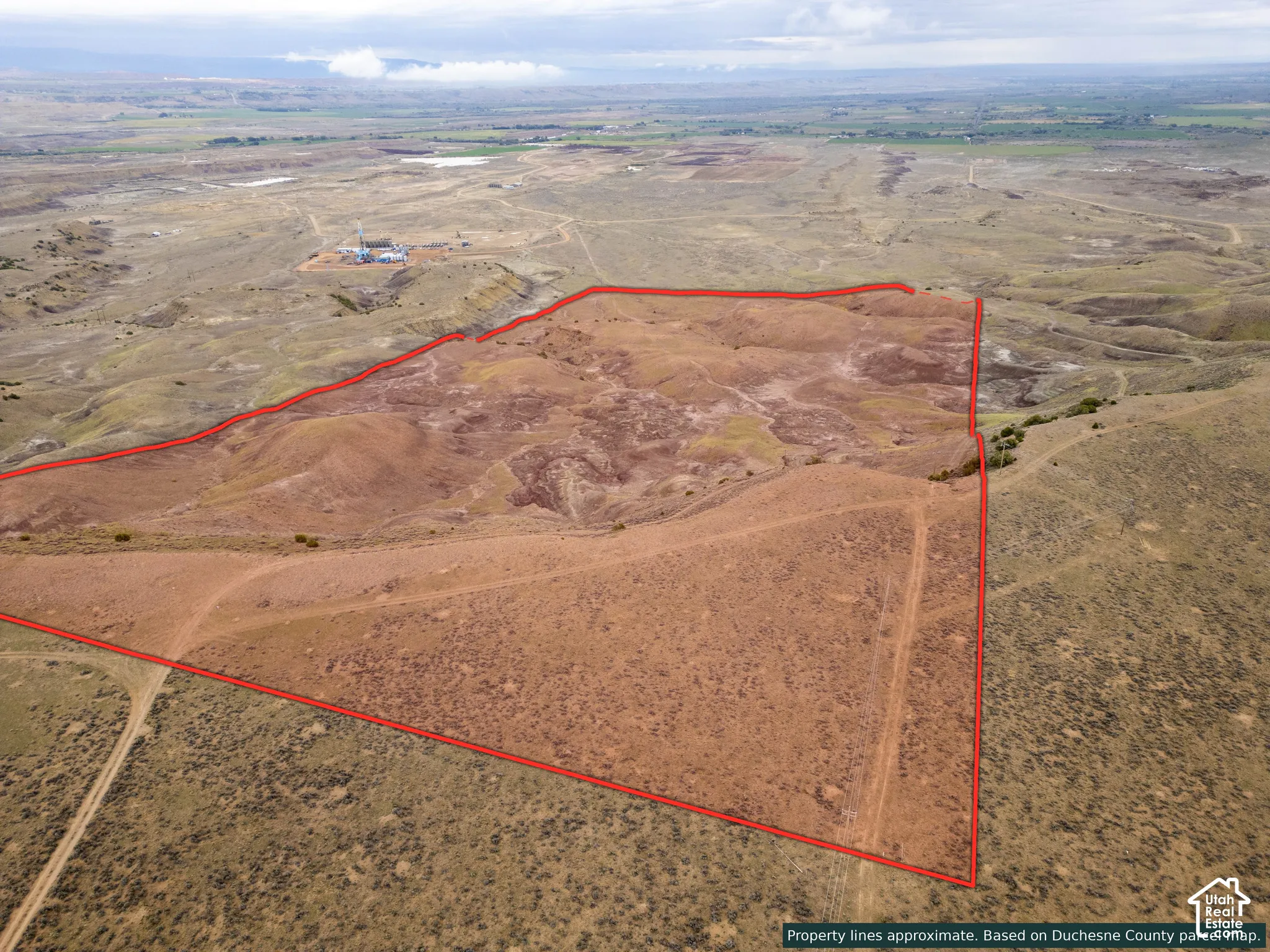 Expansive acreage featuring rolling desert terrain, natural topography, and dirt access paths