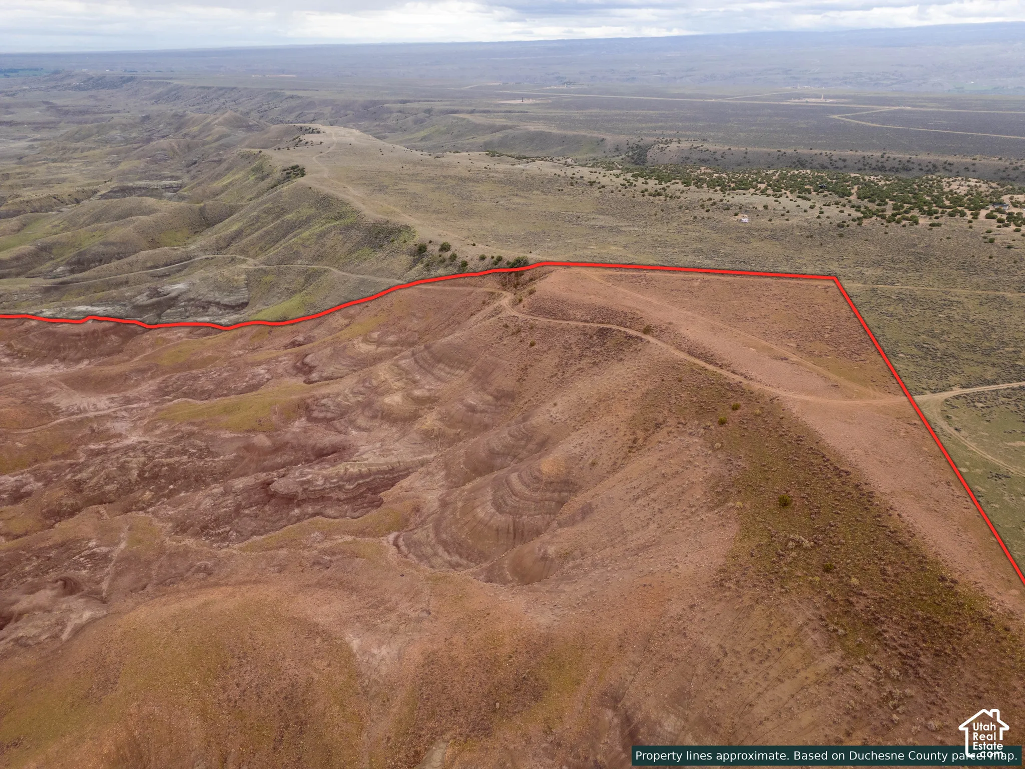Expansive parcel of land featuring elevated topography, natural red rock terrain, and desert vegetation