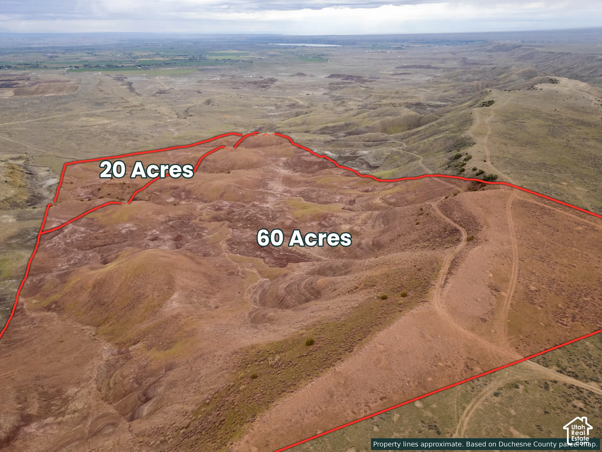 Expansive 80-acre parcel featuring varied topography, prominent earthen terrain, and natural desert vegetation