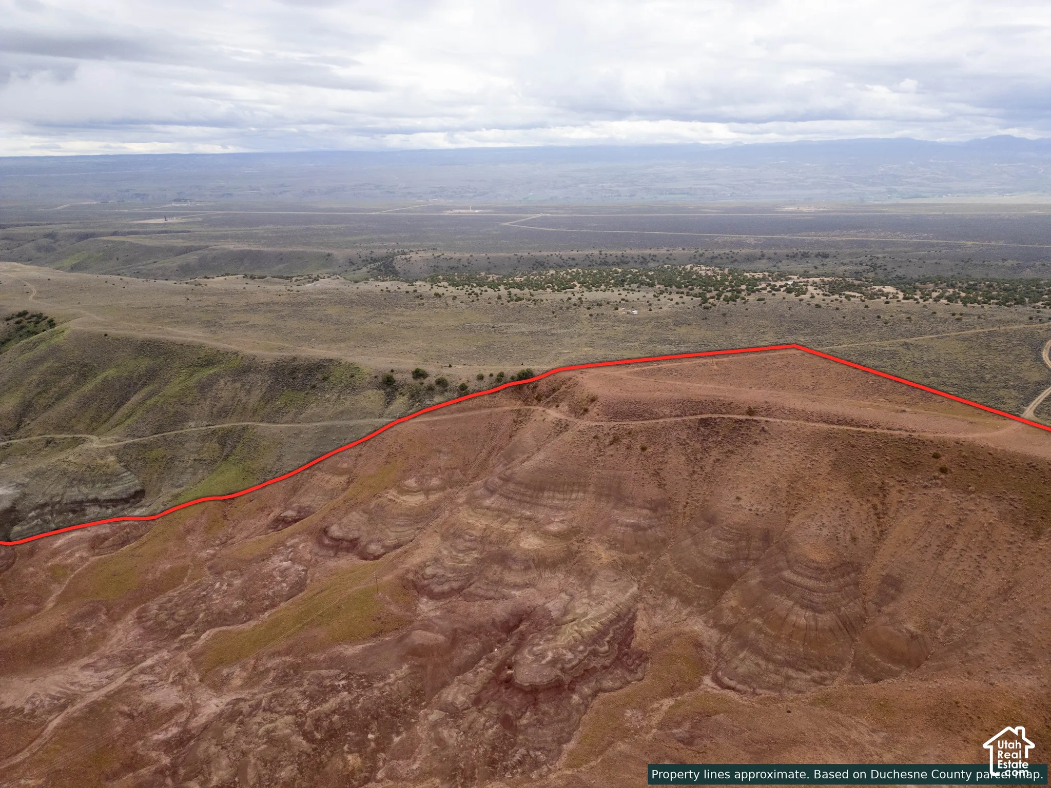 Expansive undeveloped terrain featuring elevated topography, natural rock formations, and broad horizon lines