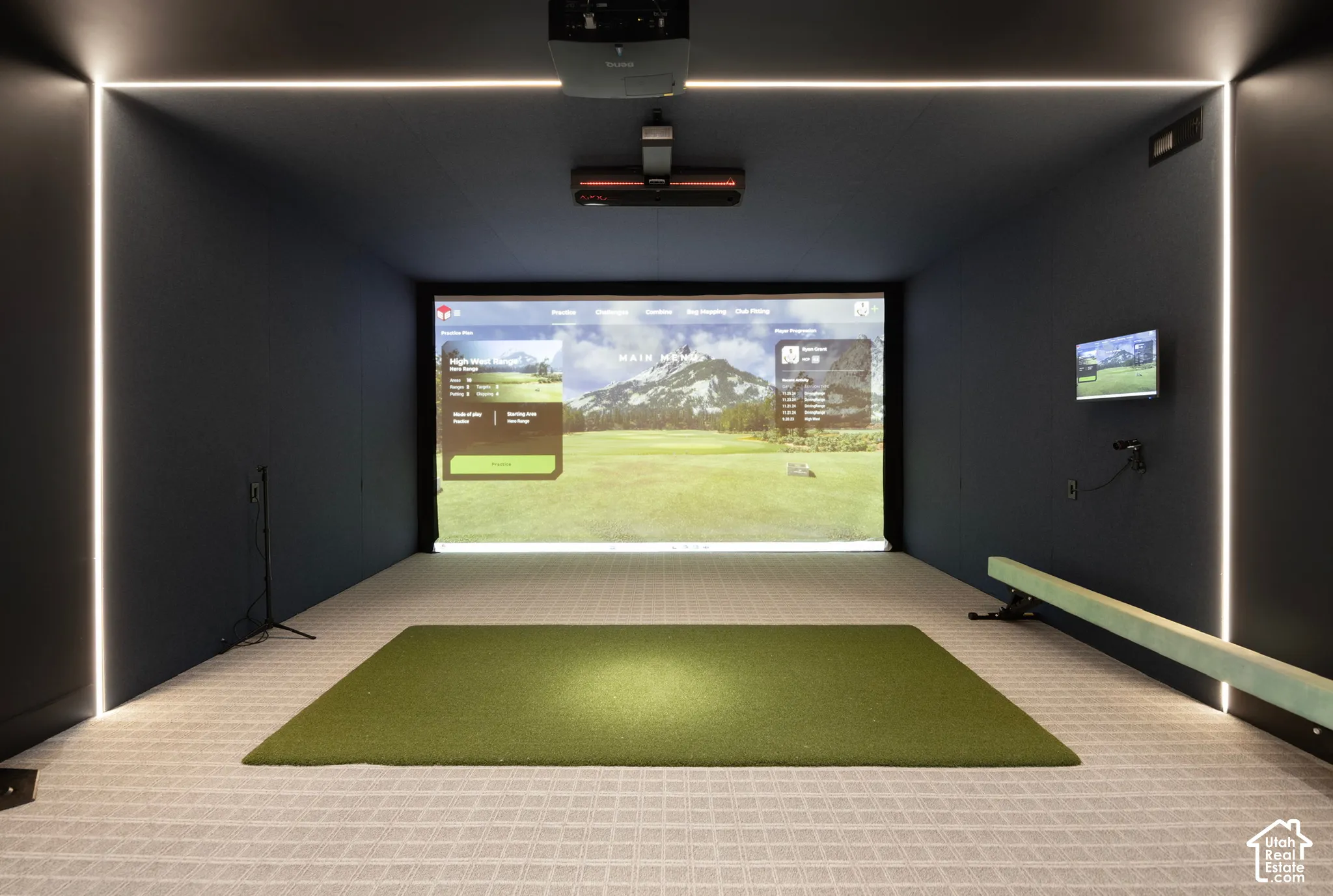 Media room featuring a wall-mounted projection screen, built-in ceiling projector, integrated vertical LED strip lighting, and impact-resistant wall panels