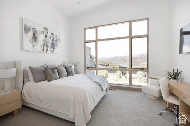 Vaulted ceiling, expansive multi-pane windows, and mountain scenery