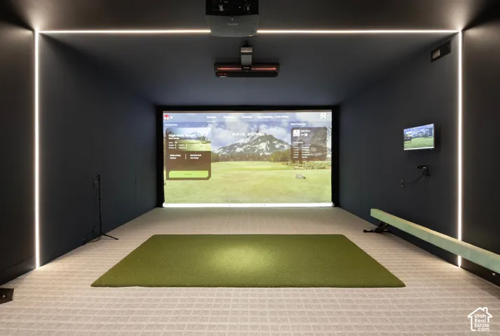 Media room featuring a wall-mounted projection screen, built-in ceiling projector, integrated vertical LED strip lighting, and impact-resistant wall panels