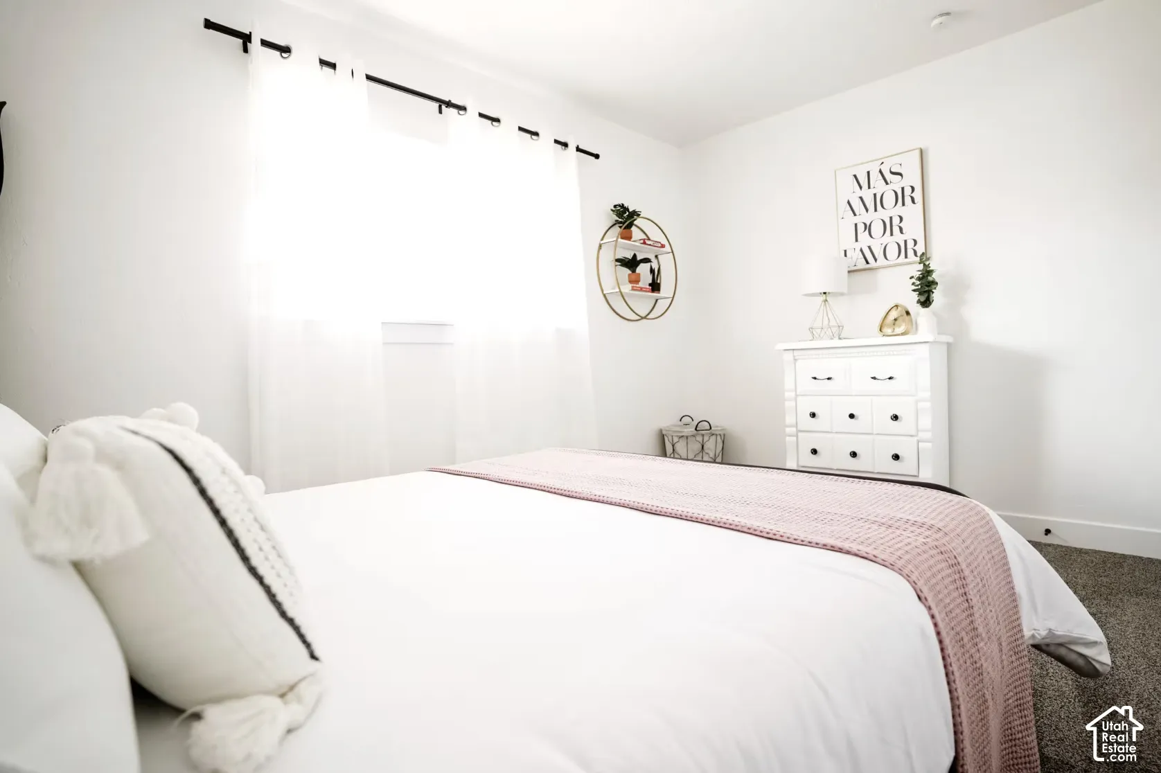 Neutral-toned walls, expansive window with an installed curtain rod, and wall-to-wall carpeting