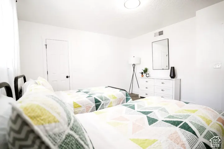 Neutral interior featuring white walls, a flush-mount ceiling light fixture, and a solid-core interior door with a circular knob