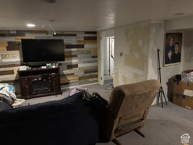 Accent wall featuring multicolored reclaimed wood-finish planks and recessed ceiling lighting