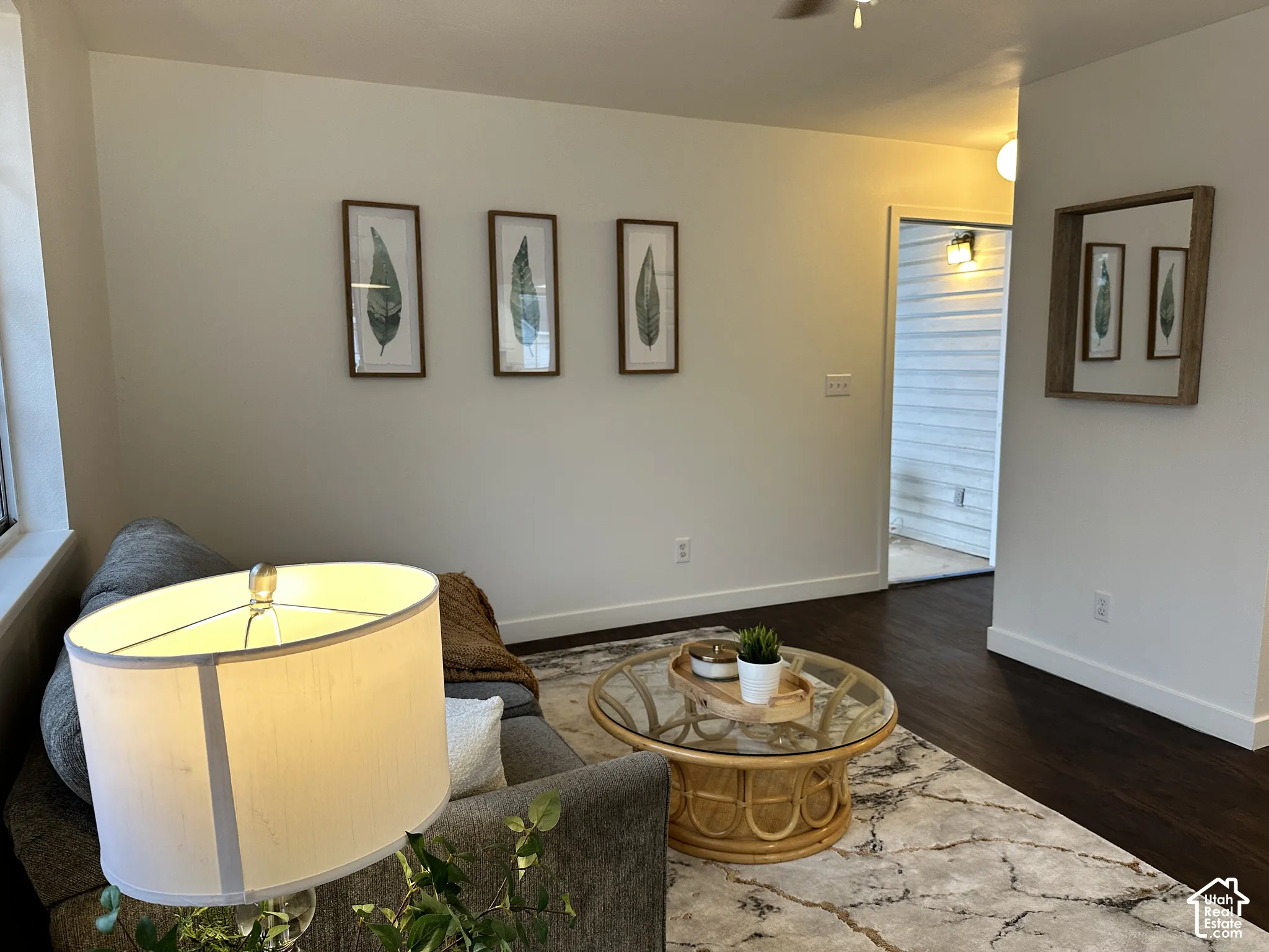 Neutral wall tones, dark wood-finish flooring, and recessed ceiling lighting