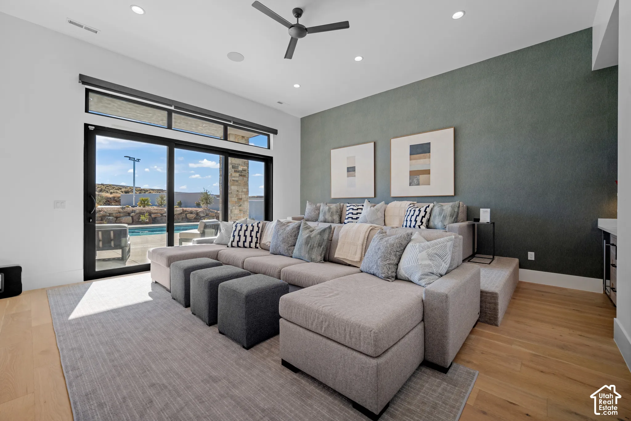 Theater room with tiered seating and sliders to the pool