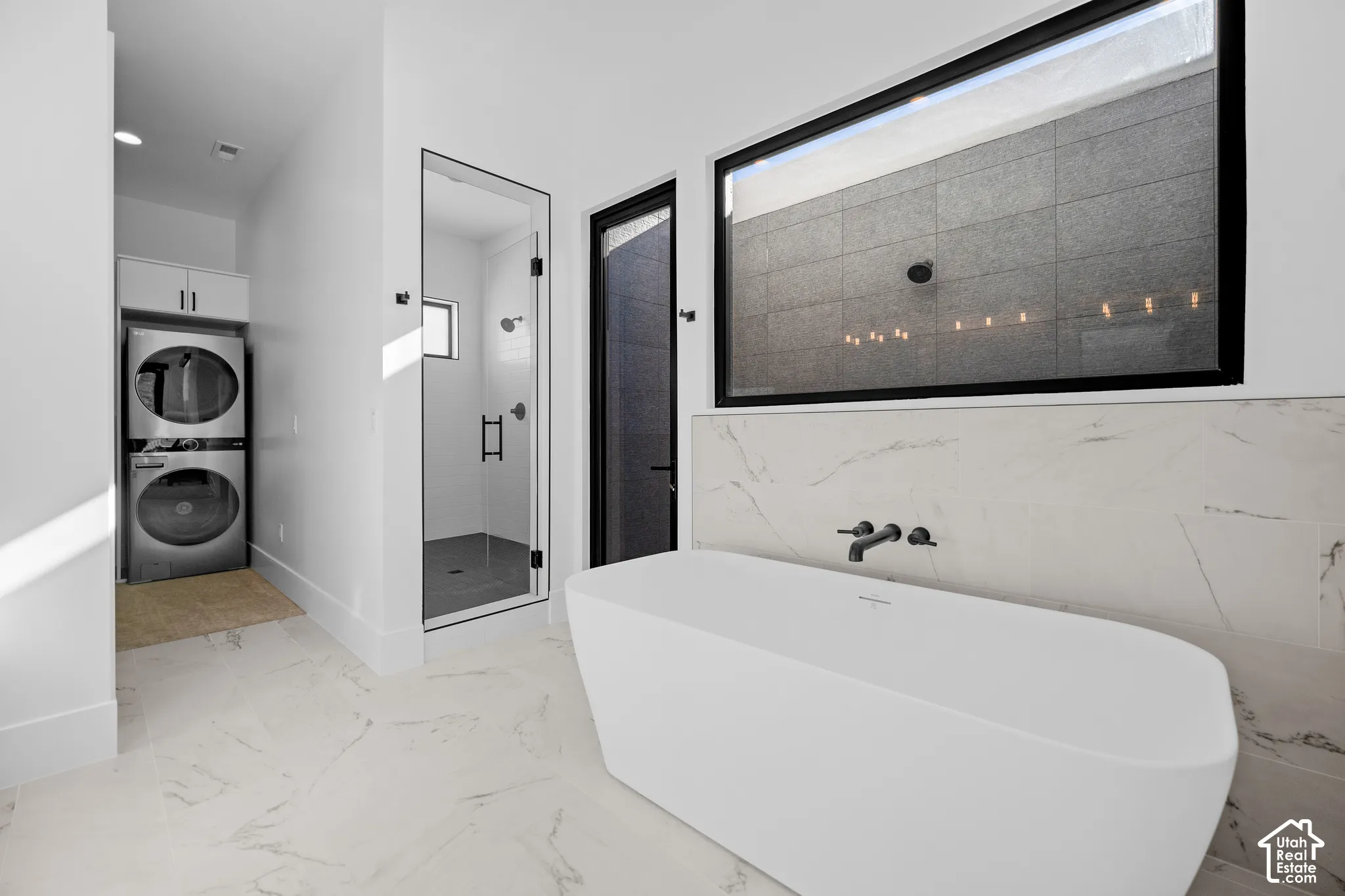 Main primary bath with freestanding tub, indoor shower and view to the private open-air shower