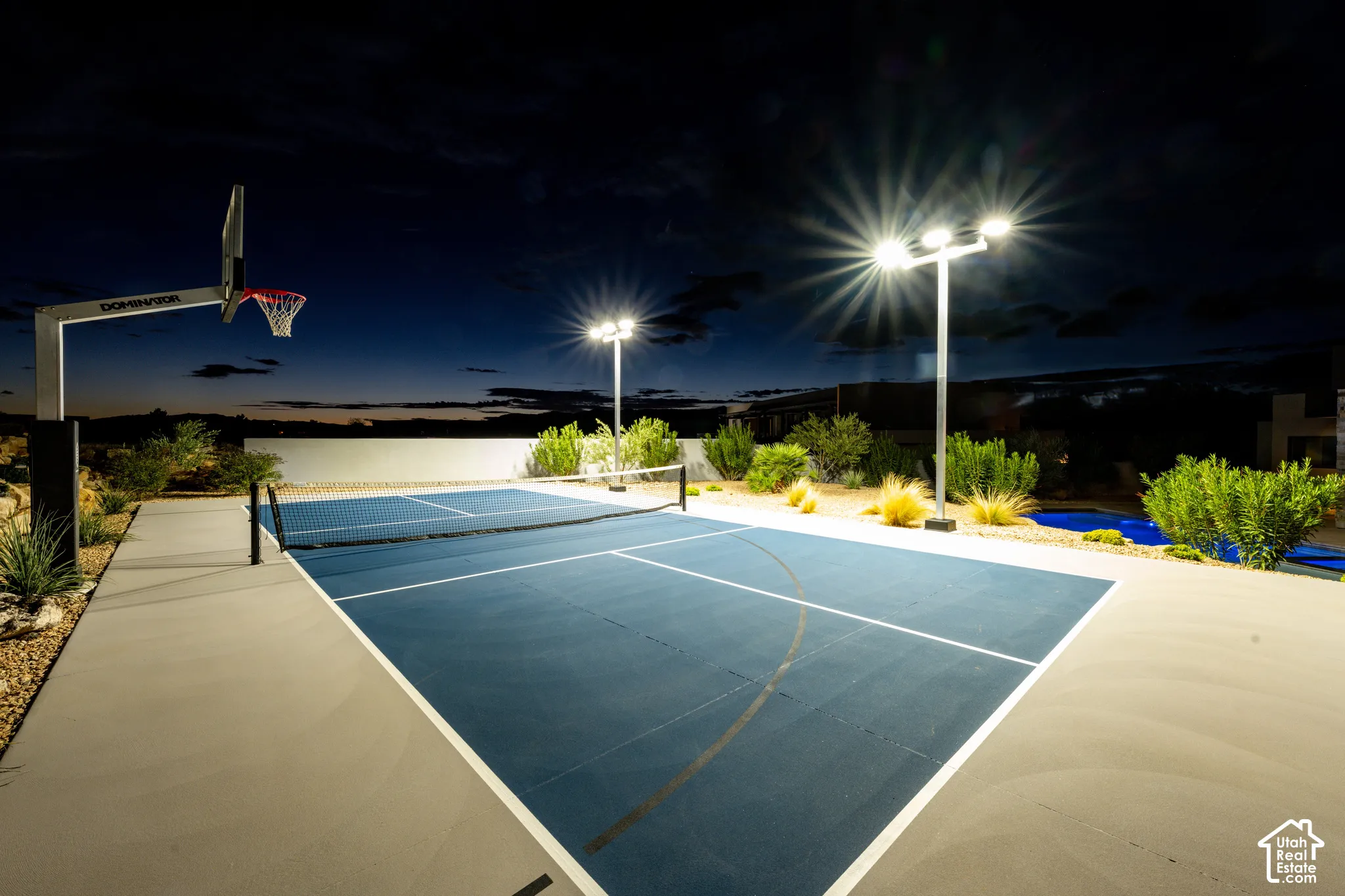 Lighted pickleball/basketball court at night
