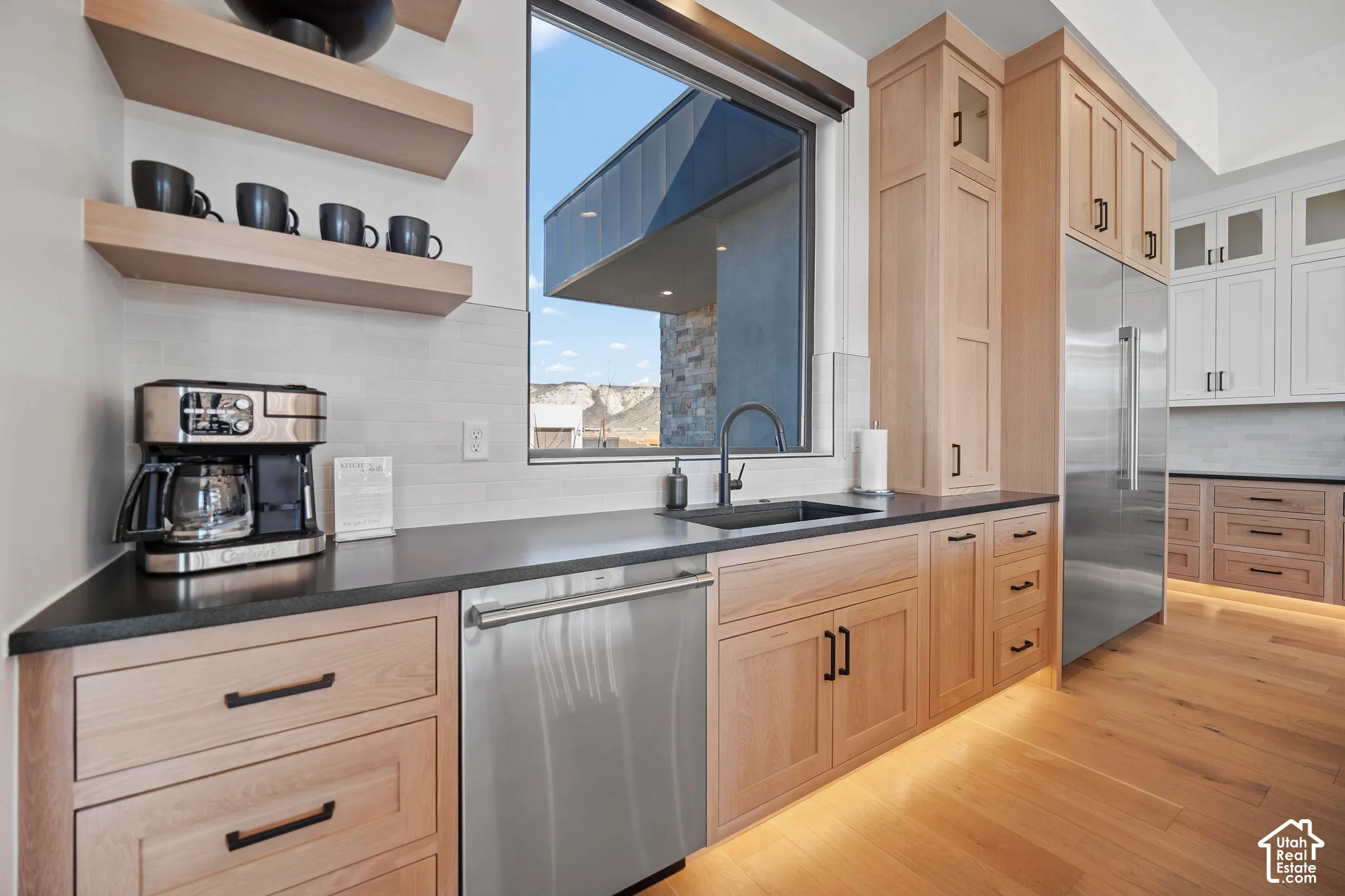 Kitchen sink with window, floating shelves and coffee station