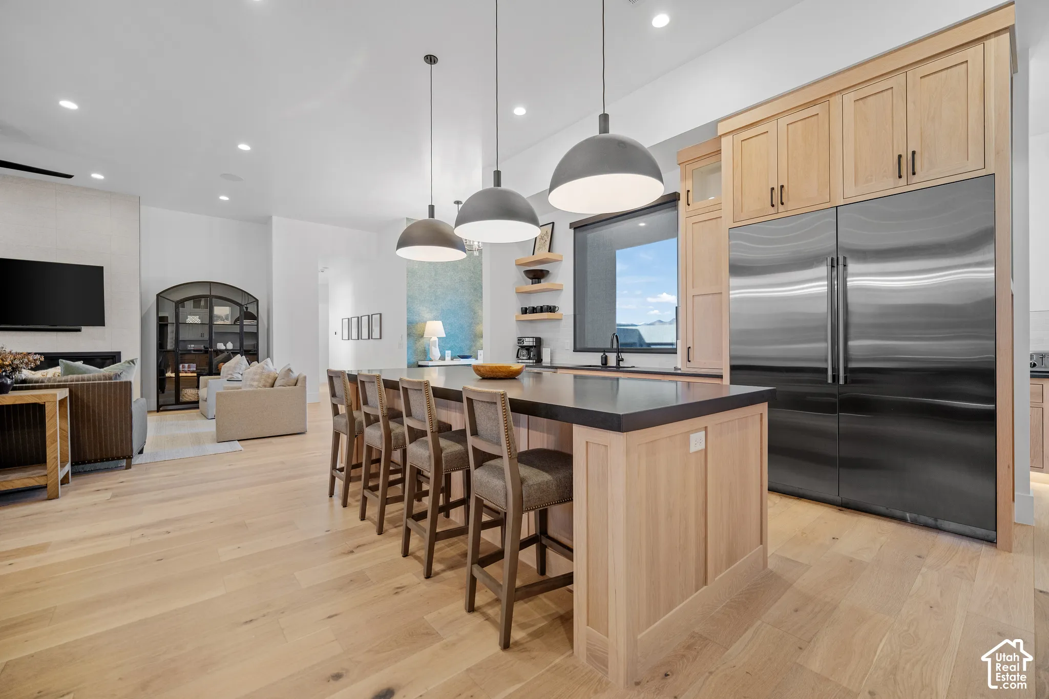 Gourmet kitchen with oversized island and Monogram refrigerator and freezer columns