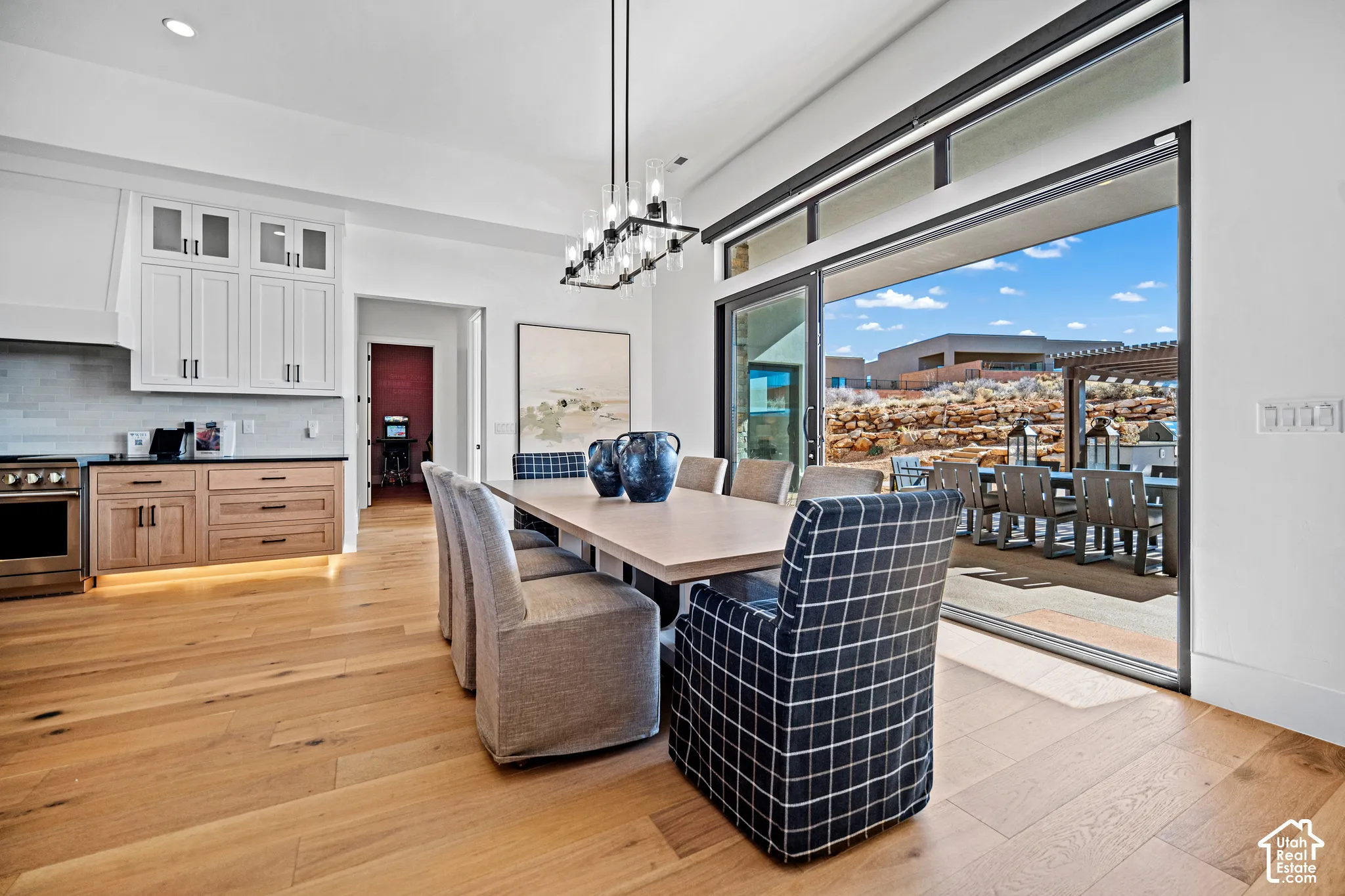 Dining room with sliders open to the patio and red rock views