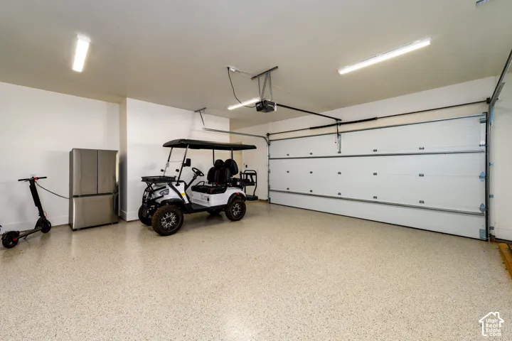 Private owner garage with epoxy floor and room for the golf cart