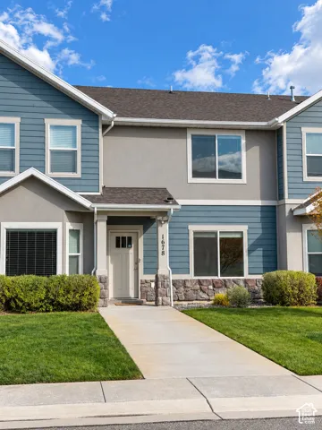 Exterior featuring horizontal siding, stucco finish, stone veneer accents, and a covered entryway
