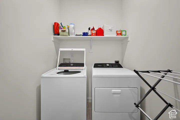 Dedicated laundry space featuring a white built-in wall shelf