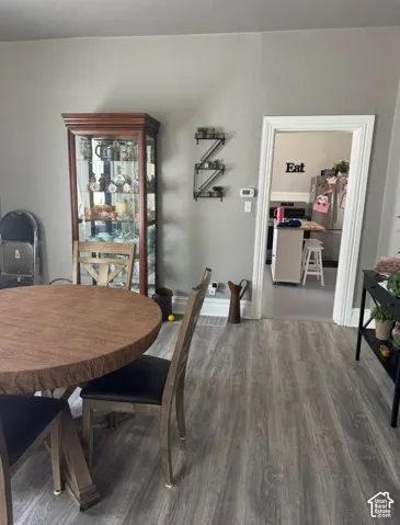 Wood-finish flooring throughout, neutral wall color, and substantial door casing framing the interior entryway
