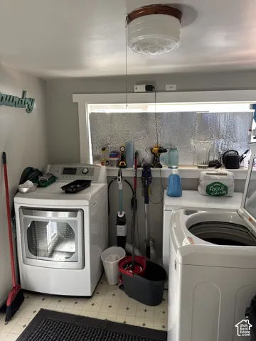 Laundry space featuring a horizontal window with white trim and a flush-mount circular ceiling light fixture