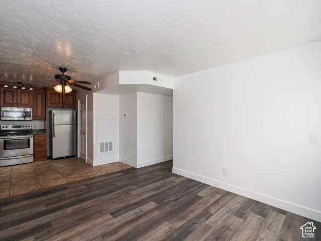 Open living area featuring new luxury vinyl plank flooring, board-and-batten wainscoting, and open flow to kitchen and dining