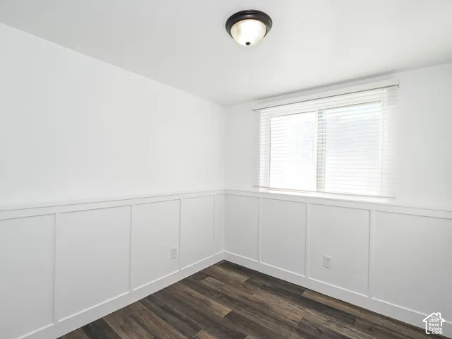 Bedroom 3 featuring new luxury vinyl plank flooring, board-and-batten wainscoting, and new window blinds