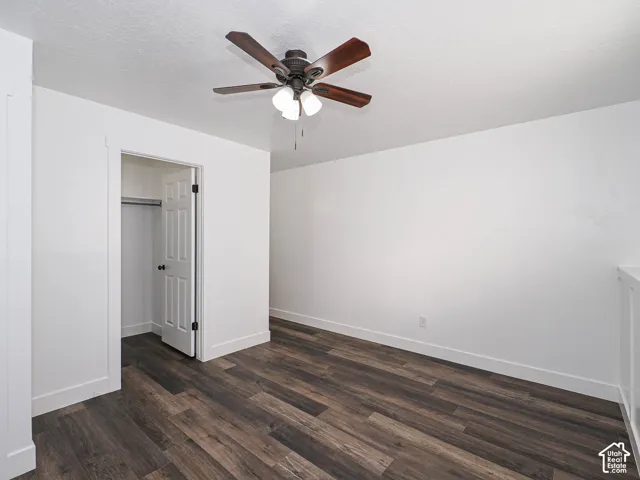 Spacious primary suite with new LVP flooring, ceiling fan, walk-in closet, and private en suite bath
