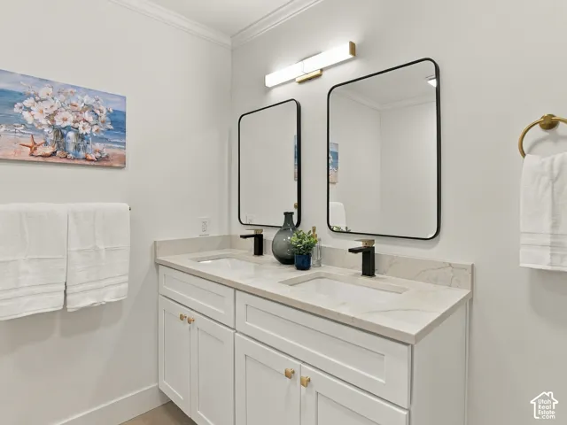 Dual-sink vanity with white shaker-style cabinetry, quartz countertop, rectangular undermount basins, matte black fixtures, and dual framed mirrors