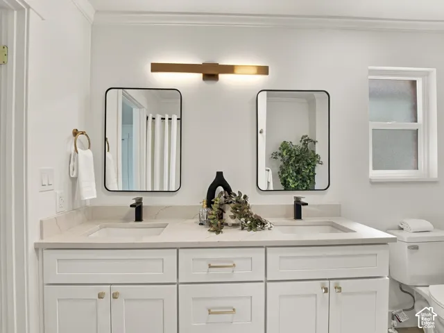 Double vanity featuring white shaker-style cabinetry, stone-composite countertop with integrated dual sinks, rectangular black-framed mirrors, matte black fixtures, and a linear wall-mounted light fixture