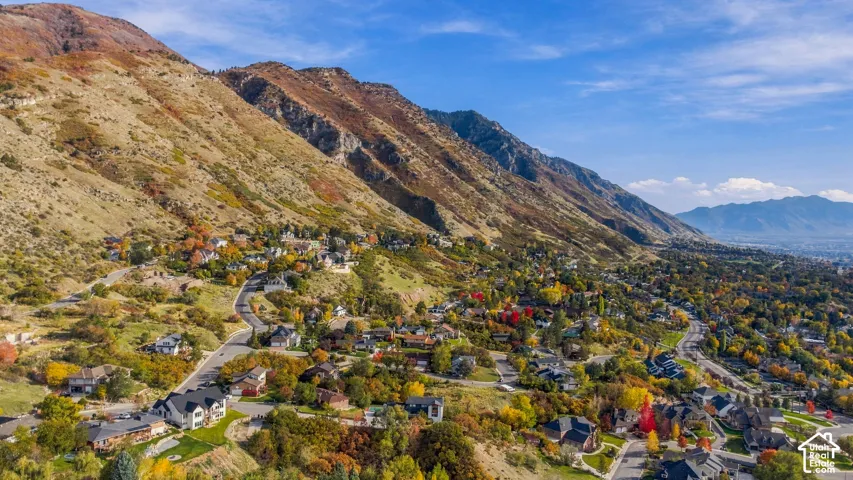 Aerial perspective featuring expansive mountainous topography and mature trees throughout the surrounding landscape