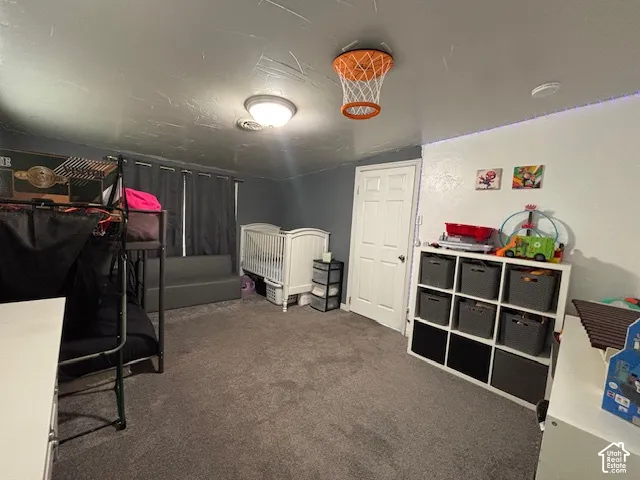 Room featuring wall-to-wall carpeting, flush-mount lighting, and a six-panel interior door