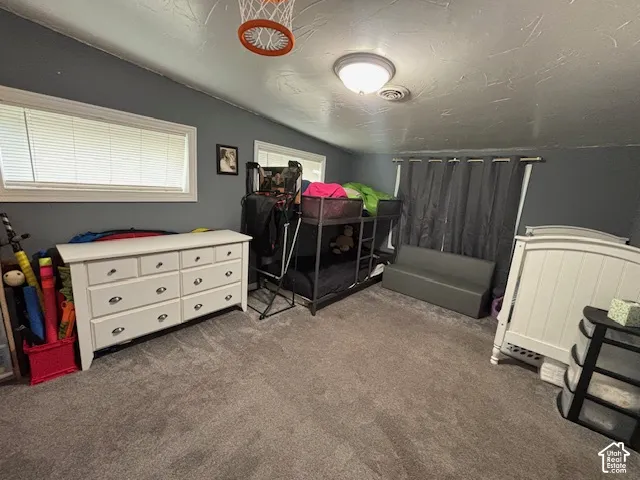 Room featuring carpeting, dual windows, and a flush-mount ceiling light fixture