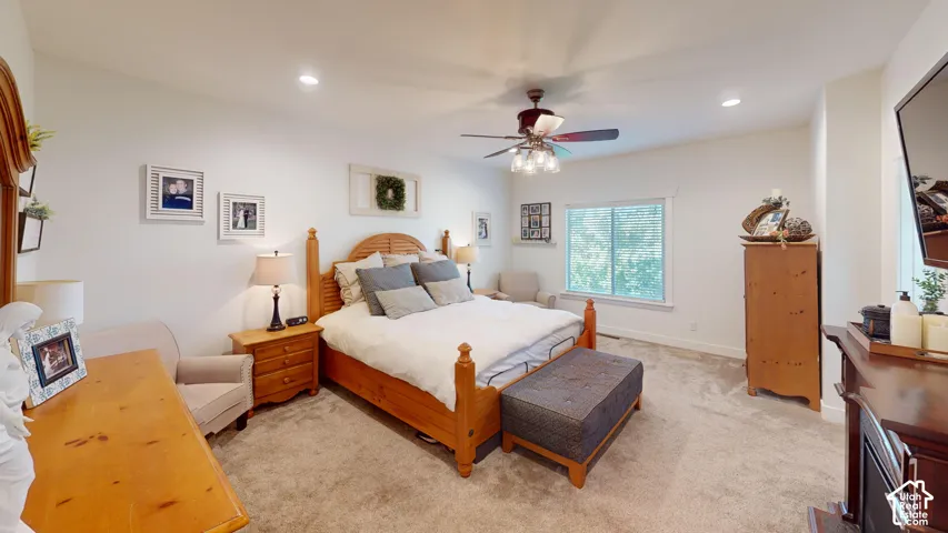 Bedroom featuring neutral carpeting, recessed lighting, ceiling fan with light fixture, and horizontal sliding window