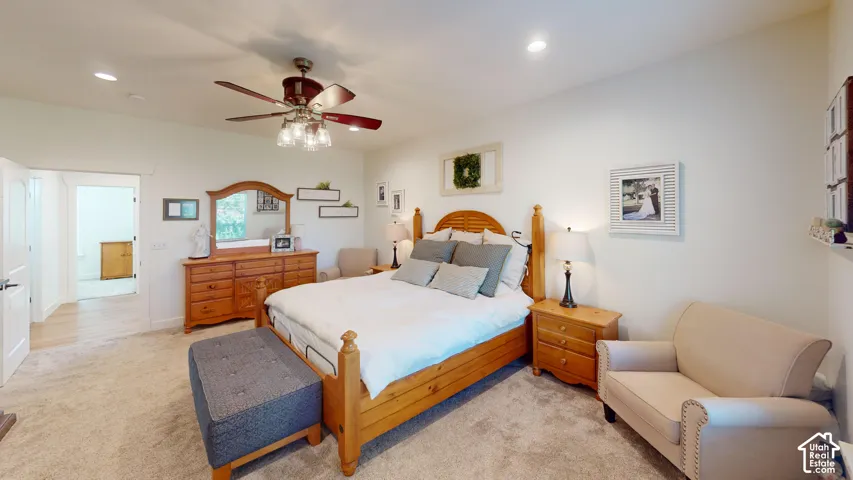Neutral interior room featuring recessed lighting, a multi-blade ceiling fan with integrated glass fixtures, and neutral carpeting