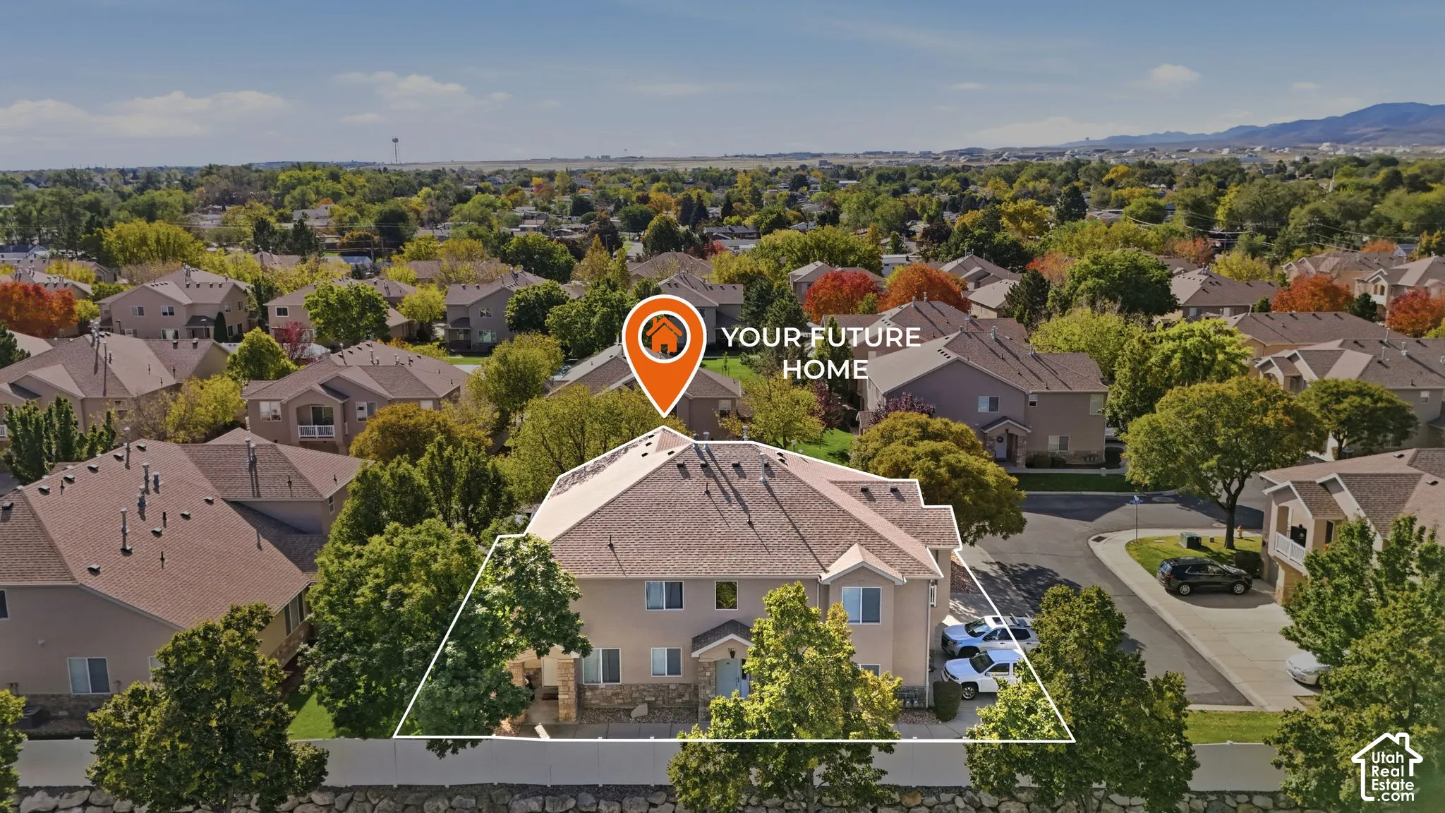 Two-story residence featuring a multi-pitched shingle roof, exterior stone veneer accents, mature landscaping, and an attached garage
