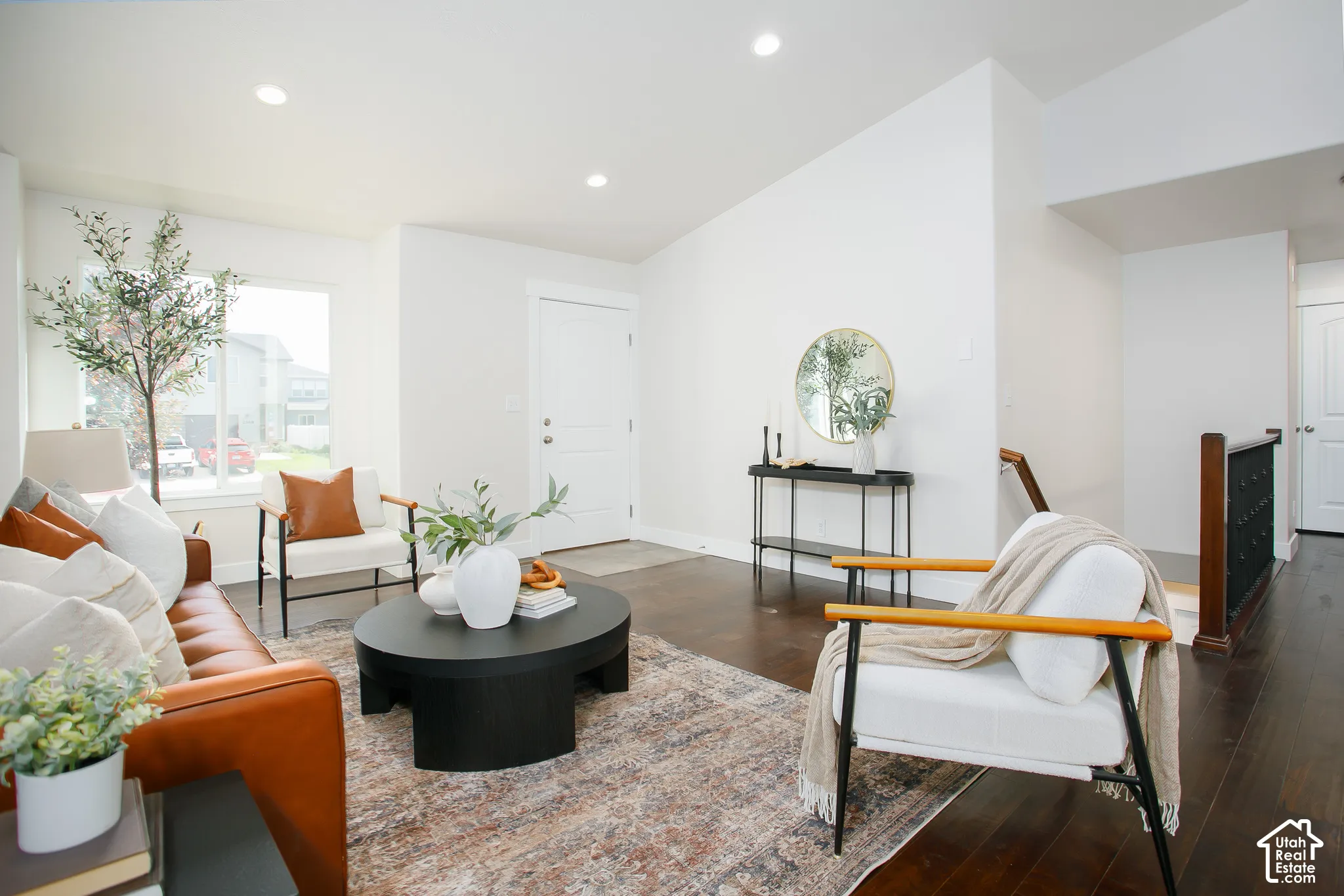 Vaulted ceilings featuring recessed lighting, dark wood-finish flooring, and a multi-panel entry door