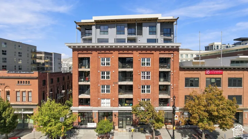 Mixed-use building featuring a brick facade with a modern upper addition