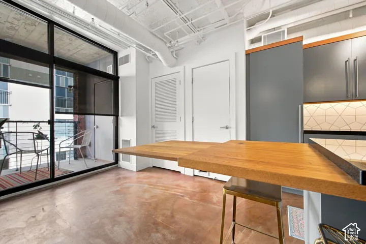 Expansive balcony with black frame glass doors