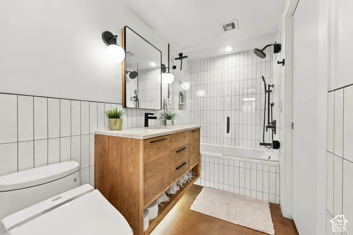 Wood-finish vanity with a stone countertop and integrated sink