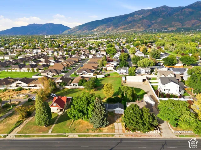 Expansive lot featuring mature trees and a mountain backdrop