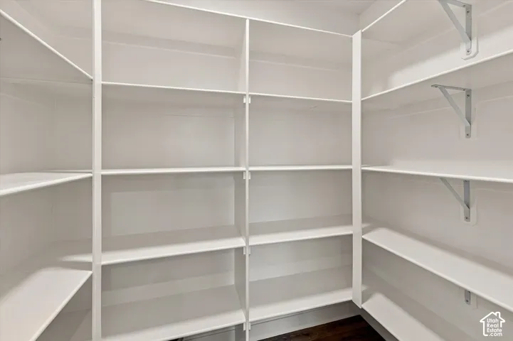 Built-in white shelving, wood-finish flooring, and adjustable metal support brackets
