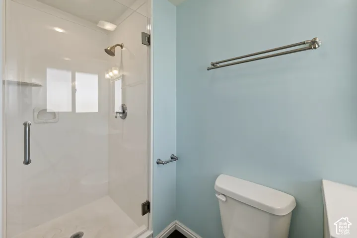 Walk-in shower with a glass door, brushed nickel hardware, integrated wall niche, and polished finish surround